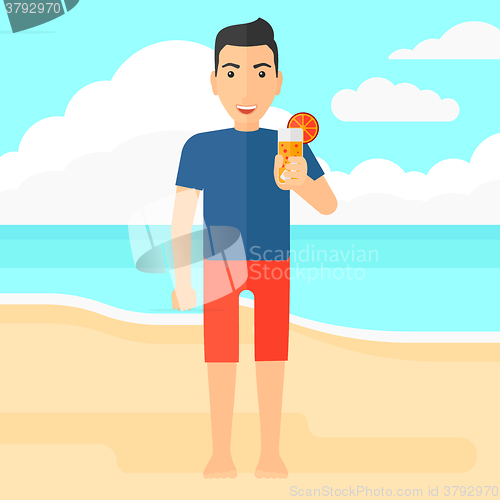 Image of Tourist with cocktail on the beach.