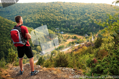 Image of Active tourist on the top of mountain enjoying landscape