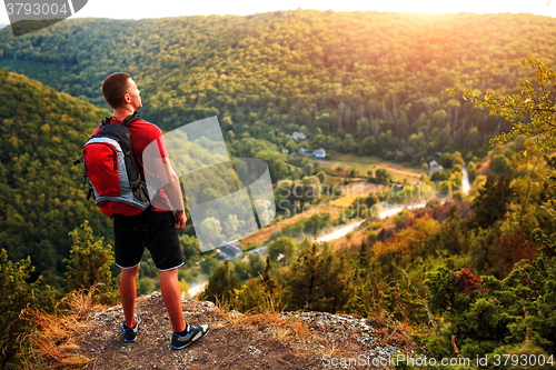 Image of Active tourist on the top of mountain enjoying landscape