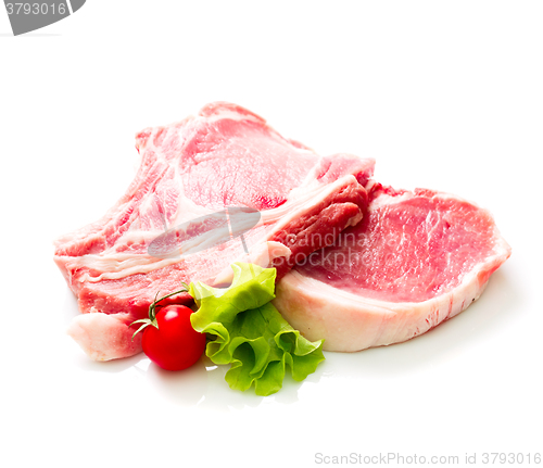 Image of Pieces of raw beef with tomato and salad isolated on white background