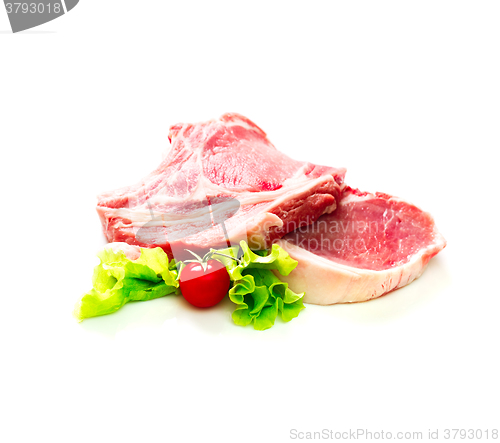 Image of Pieces of raw beef with tomato and salad isolated on white background
