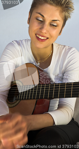 Image of woman and guitar