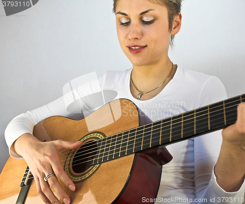 Image of woman and guitar