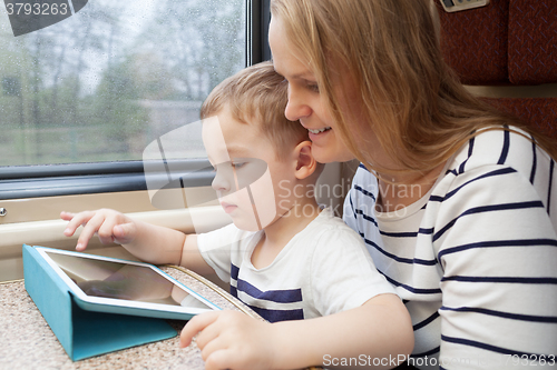 Image of Mother and her young son on a train