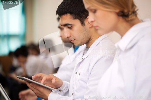 Image of Medical student working with pad on the conference