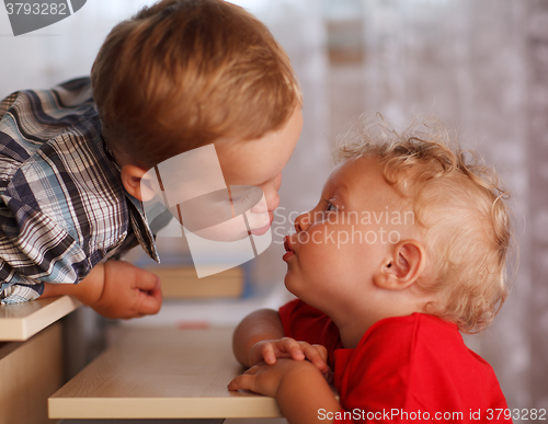 Image of Cute siblings. Two little brothers are kissing.