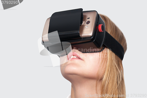 Image of Young woman entertaining with VR-Helmet