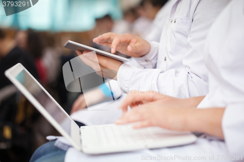 Image of Medical students with pad and laptops in auditorium