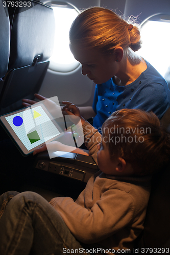 Image of Young mother and son traveling on an aeroplane