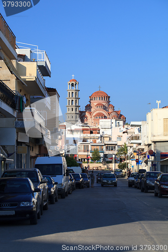 Image of Narrow street with parked cars in Greece