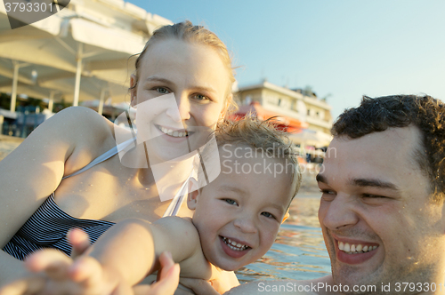 Image of Happy young family at the seaside