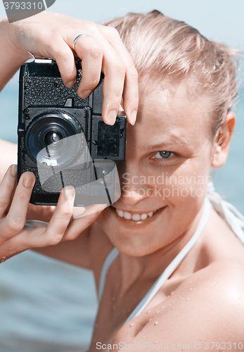 Image of Woman laughing as she views a photo