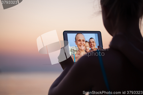 Image of Family selfie with pad on the beach