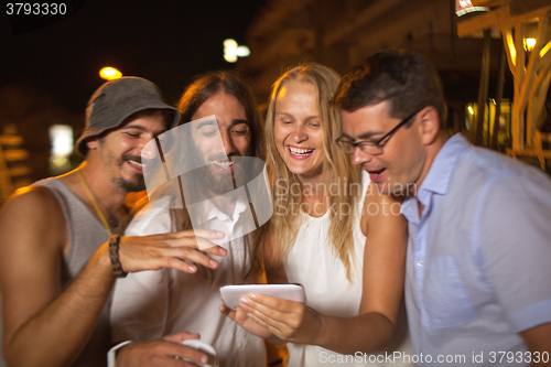 Image of Friends looking at great shots of today evening