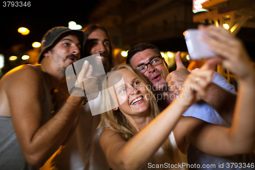 Image of Happy friends selfie with thumbs up