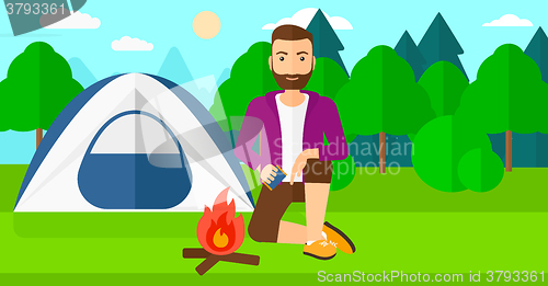 Image of Man kindling fire.