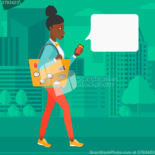 Image of Woman walking with smartphone.