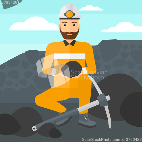 Image of Miner holding coal in hands.