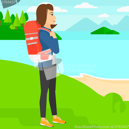 Image of Woman with backpack hiking.