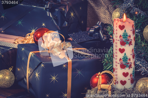 Image of Christmas gifts with a Xmas candle