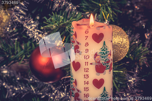 Image of Christmas candle with december calendar