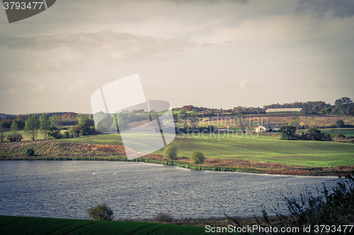 Image of Countryside landscape with a farm and a lake