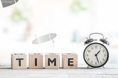 Image of Alarm clock on a wooden desk