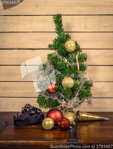 Image of Shiny baubles under a Christmas tree