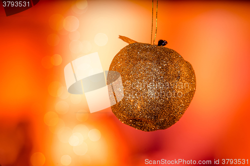 Image of Golden Christmas apple with glittering lights