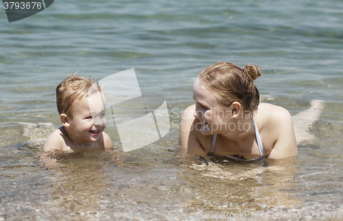 Image of Mother and son swim in the sea