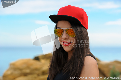 Image of Young smiling girl in red cap