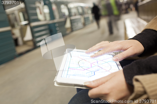 Image of Woman with pad exploring underground map