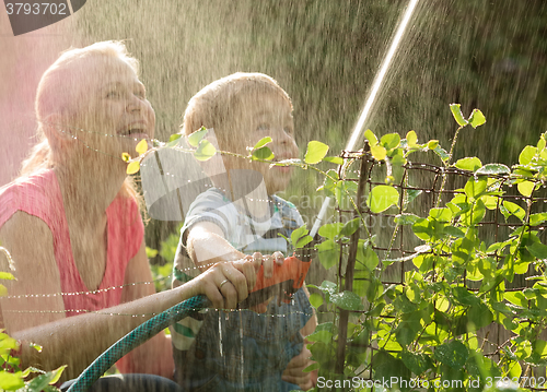 Image of Mother and her young son playing with water