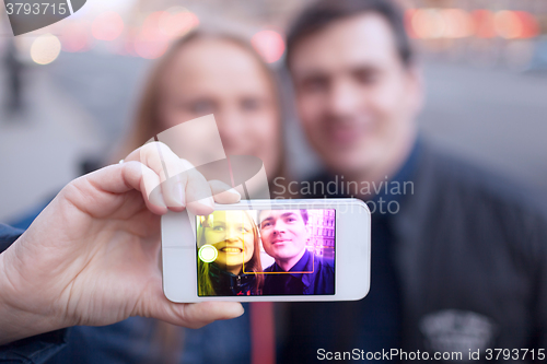 Image of Happy couple taking self portrait