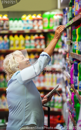 Image of Woman buying household detergents in the shop