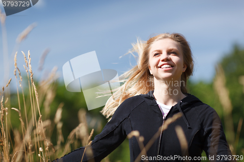 Image of Young and happy girl in the field