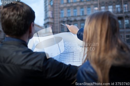 Image of Man and woman holding blueprint