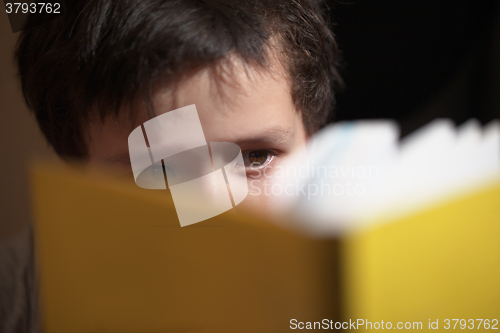 Image of Young boy reading a book