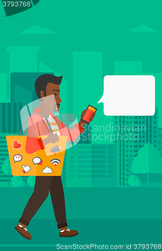 Image of Man walking with smartphone.