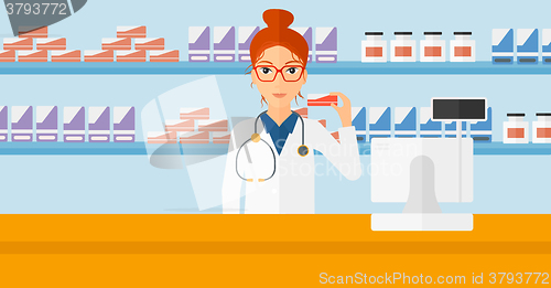 Image of Pharmacist showing some medicine.