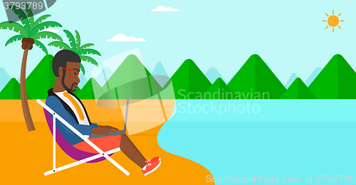 Image of Businessman sitting in chaise lounge with laptop.
