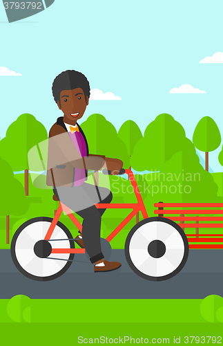 Image of Man riding bicycle.
