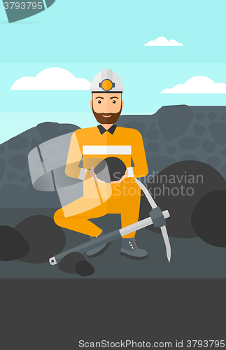 Image of Miner holding coal in hands.