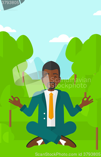 Image of Businessman meditating in lotus pose.