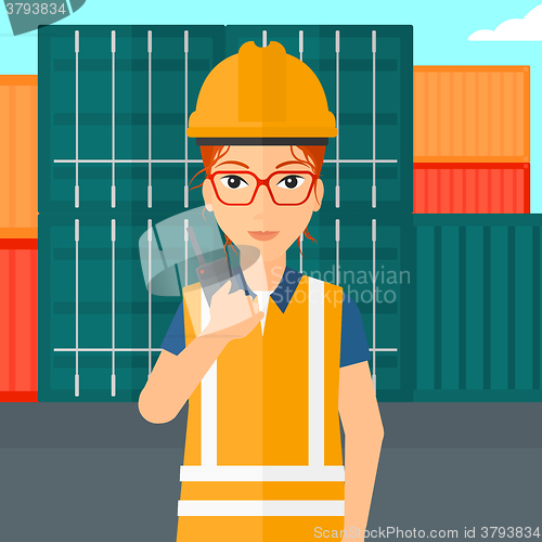 Image of Stevedore standing on cargo containers background.