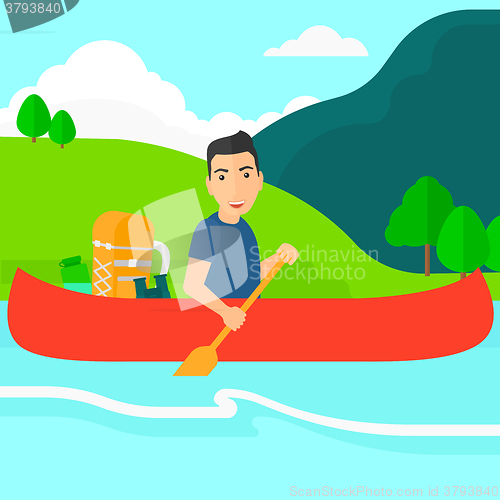 Image of Man canoeing on the river.