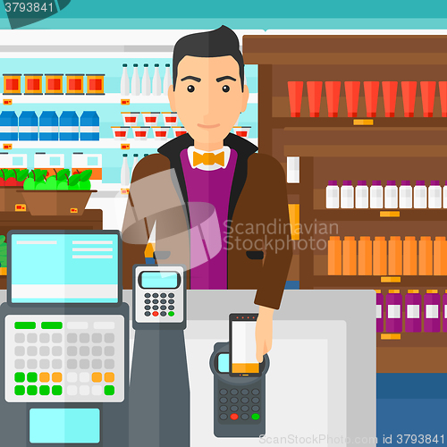 Image of Customer paying with his smartphone using terminal.