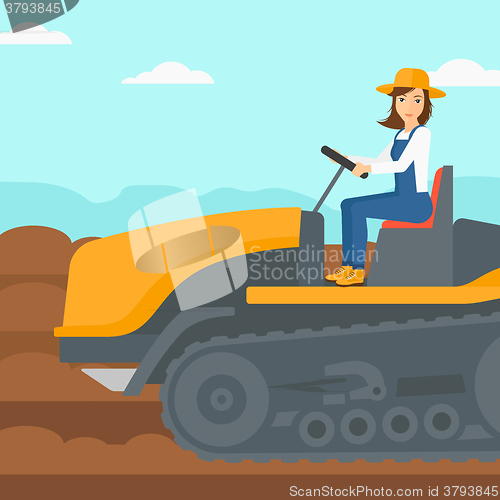 Image of Farmer driving catepillar tractor.