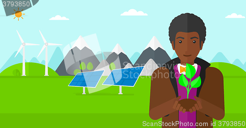Image of Man holding plant.