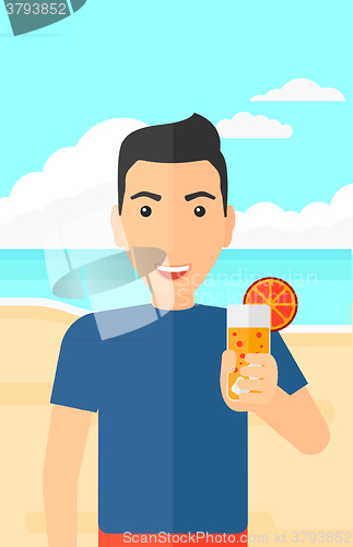 Image of Tourist with cocktail on the beach.